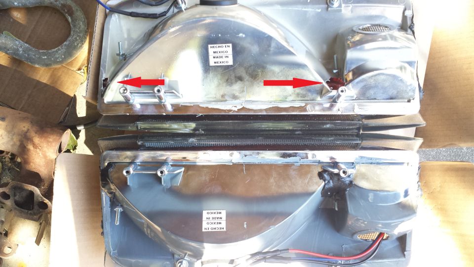 Two chrome headlights with red arrows pointing to mounting points