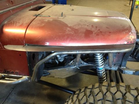 1985 Jeep CJ7 - This Jeep CJ7 shows off its custom suspension and roll cage, with "Jeep" visible on the body panel.