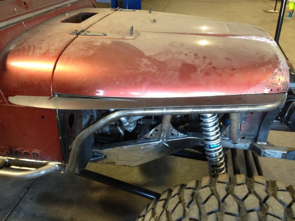 Red Jeep CJ7 body and suspension with custom roll cage and large tires
