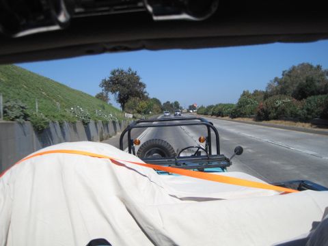 1989 Ford Bronco - Driving on the highway in a Jeep CJ-7, with a spare tire mounted on the back.