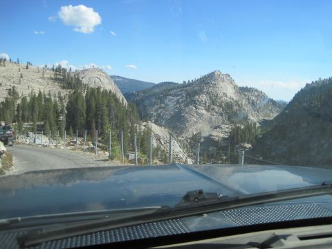 1989 Ford Bronco - View from inside a vehicle driving through a scenic mountain pass on a clear day.