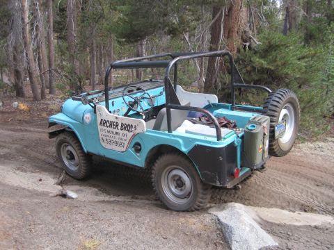 1989 Ford Bronco - This light blue jeep, marked with 'Archer Bros.', navigates a dirt path in a wooded area.