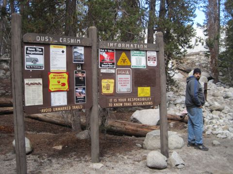1989 Ford Bronco - Photo of a wooden trailhead information board with posted flyers; environmental scene, not a technical vehicle document.