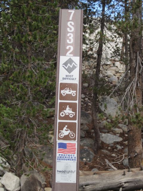 1989 Ford Bronco - A trail marker sign displays trail numbers, a difficulty rating, and icons for various off-road vehicles.