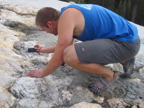 1989 Ford Bronco - A man examines the rocky terrain while holding a digital camera.