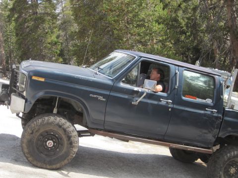 1989 Ford Bronco - A modified pickup truck, likely from the early 1980s, is shown off-road.