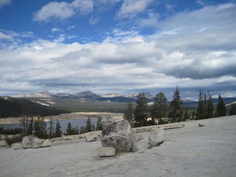 1989 Ford Bronco - A vast landscape unfolds with a tranquil lake, mountains, and dramatic clouds overhead.