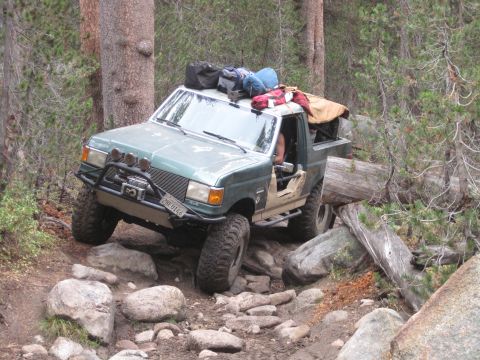 1989 Ford Bronco - This modified 1989 Ford Bronco tackles a challenging off-road path, loaded with gear for an adventure.