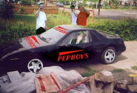 1994 Ford Crown Victoria - A black coupe with Pep Boys decals is parked outdoors with people around.