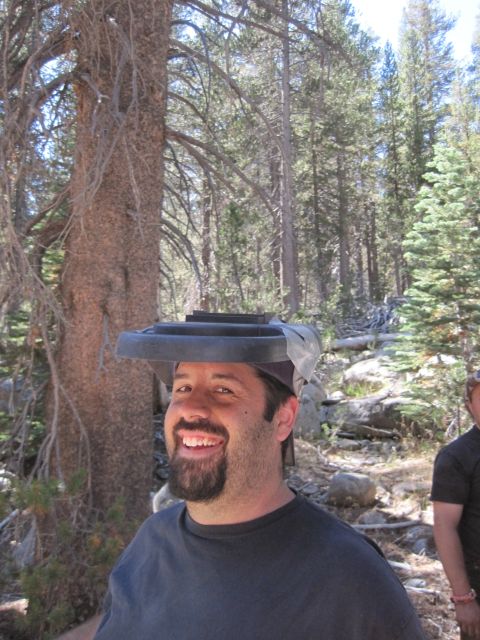 1989 Ford Bronco - A man smiles while wearing a trash can lid as a hat in a wooded area.