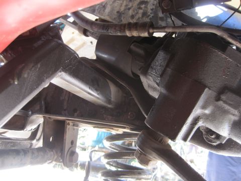 1989 Ford Bronco - Undercarriage view shows steering and suspension parts, including a coil spring and linkage.