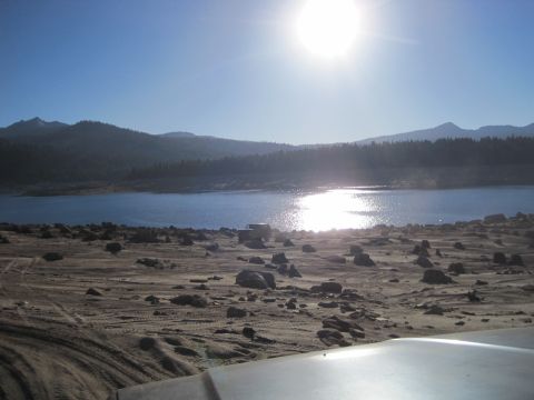 1989 Ford Bronco - A sunny day at the lake with an off-road vehicle parked on the shore.