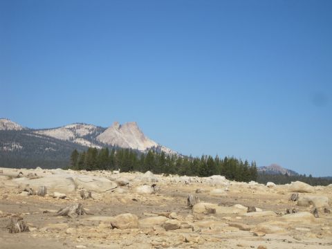 1989 Ford Bronco - A wide view of a mountain landscape under a clear blue sky, a rocky terrain in the foreground.
