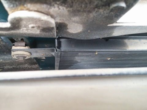 2000 Mercury Grand Marquis - Close-up view of a vehicle's radiator and its mounting hardware.