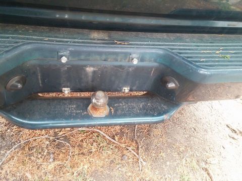 2000 Mercury Grand Marquis - Close-up of a rear bumper assembly a trailer hitch and embossed text indicating load capacity.