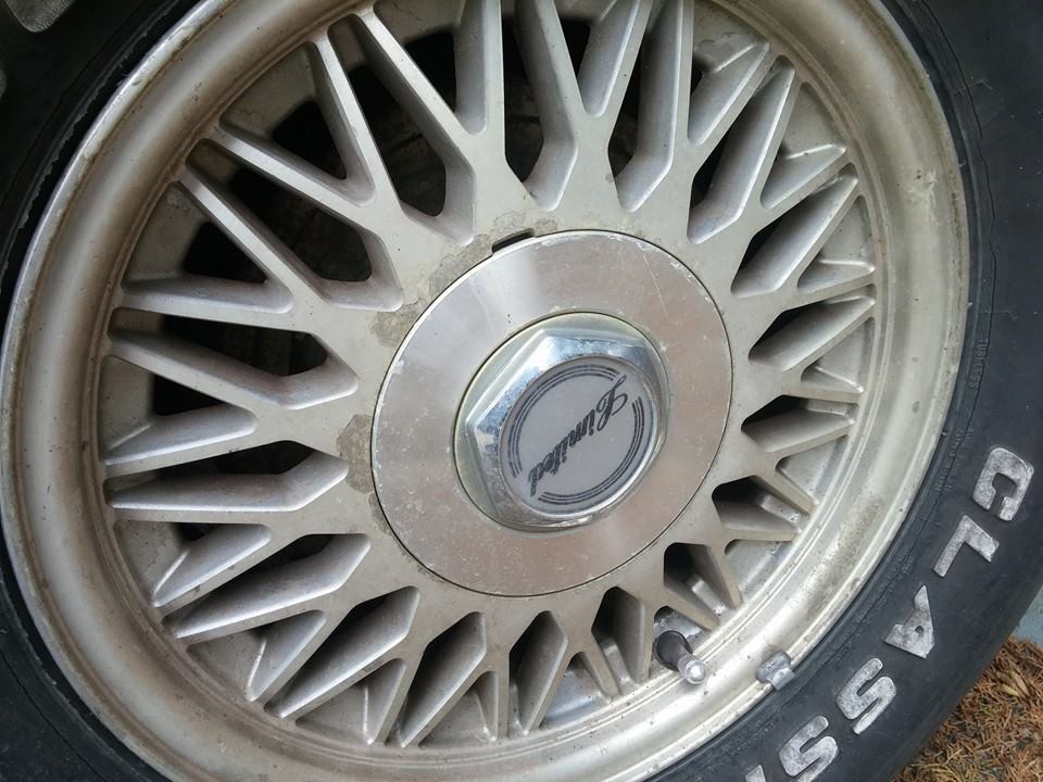 Aluminum wheel with 'Limited' center cap and tire sidewall text