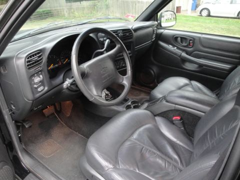 2001 Ford Crown Victoria - The interior of a truck shows the driver's side dashboard, steering wheel, and front seats.