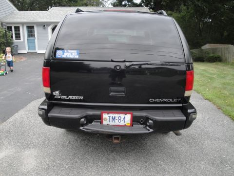 2001 Ford Crown Victoria - Rear view of a black Chevrolet Blazer SUV, showing its license plate and a sticker on the rear window.