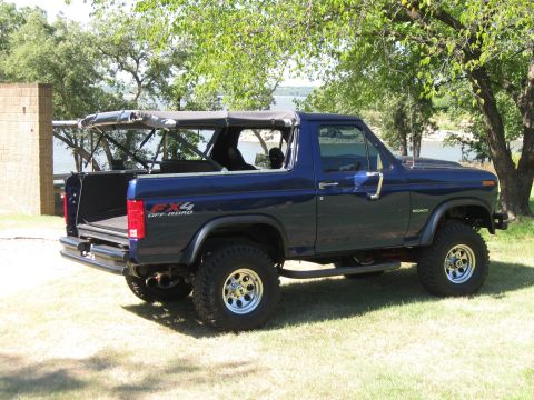 1982 Ford Bronco - This blue Ford Bronco has an FX4 Off Road decal on the fender and a removable soft top.