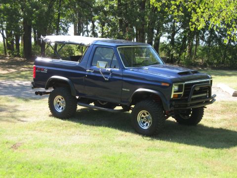 1982 Ford Bronco - This lifted blue Ford Bronco features a removable soft top and an aggressive aftermarket front bumper.