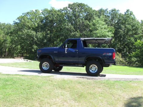 1982 Ford Bronco - This blue 1982 Ford Bronco features a removable soft top and is shown in a side profile.