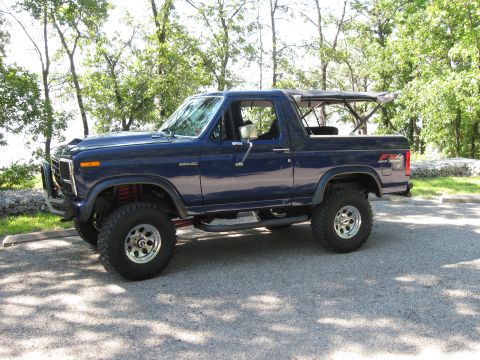 1982 Ford Bronco - This lifted blue Ford Bronco has an aftermarket front bumper and side steps.