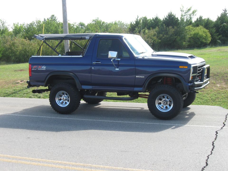 Blue 1982 Ford Bronco with soft top and lifted suspension