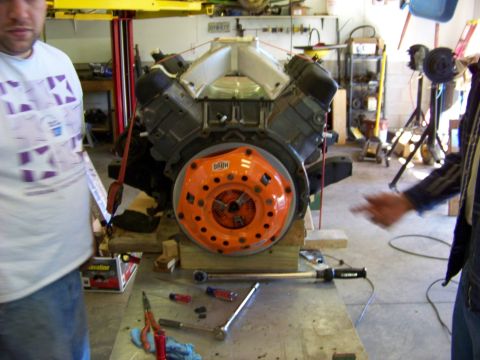 1974 Dodge Challenger - Engine and clutch assembly on display in a workshop setting with tools nearby.