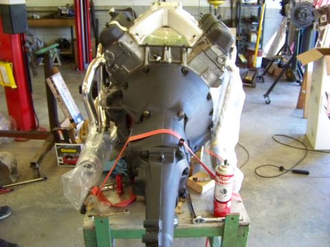 1974 Dodge Challenger - An engine and transmission assembly is prepared for installation in a workshop setting.