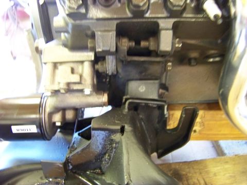 1974 Dodge Challenger - A close-up view of a vehicle's engine mount bracket and a filter with visible text.