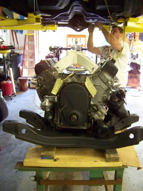 1974 Dodge Challenger - Engine assembly on a stand, ready for installation under a vehicle lifted on a car lift.