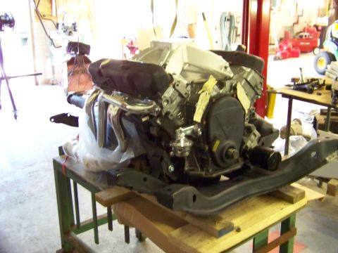 1974 Dodge Challenger - Engine assembly with chrome headers and black valve covers is prepared for installation.