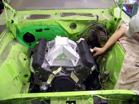 1974 Dodge Challenger - Installing a V8 engine into a 1974 Dodge Challenger, focusing on the engine bay and intake manifold.