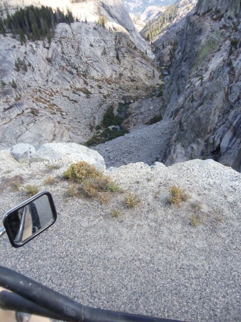 1968 Ford Bronco - Looking down a steep, rocky mountain pass from the perspective of a vehicle.