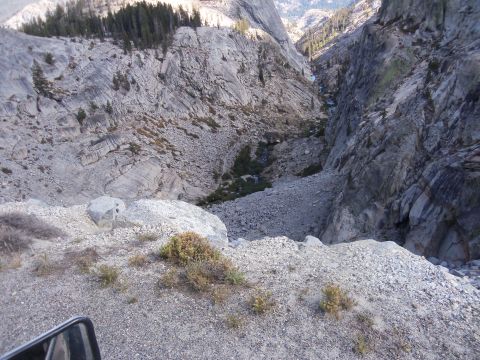 1968 Ford Bronco - A vehicle's side mirror is visible in the foreground, looking out over a vast, mountain canyon.