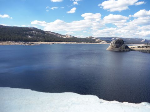 1968 Ford Bronco - Scenic view of a lake with a distinctive rock formation and distant mountains.