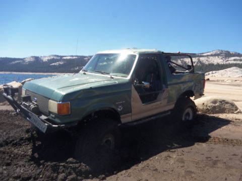 1968 Ford Bronco - This modified SUV, likely from the late 1980s, is shown off-road with its doors removed.