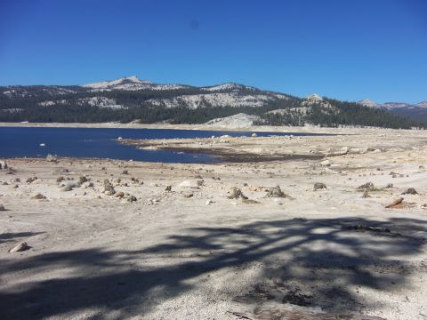 1968 Ford Bronco - A wide view of a dry landscape with a lake and mountains under a clear blue sky.