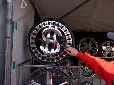 1990 Ford Bronco - Custom rims with a dollar sign design are displayed for sale.