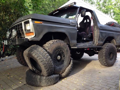 1979 Ford Bronco - This heavily modified Ford Bronco features large off-road tires and a roll cage inside.
