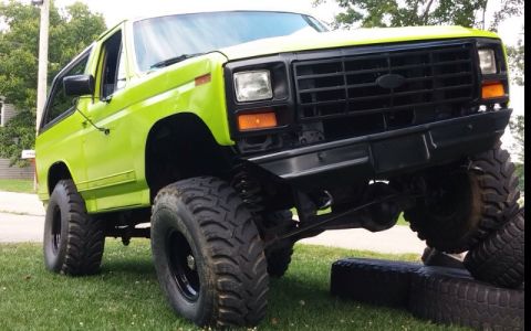 1979 Ford Bronco - This modified Ford Bronco sits with its front tires elevated on a grassy area.