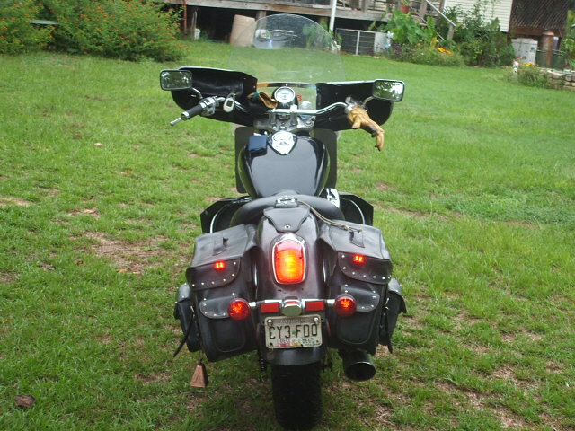 Back view of a black motorcycle with saddlebags and a license plate that reads CY3-F00