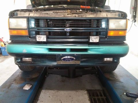 2000 Mercury Grand Marquis - Front view of a green Ford Explorer on a lift, showing the grille and headlights.