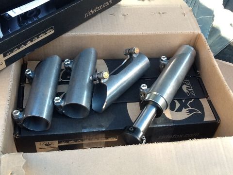 1985 Jeep CJ7 - Unboxed Fox shock absorbers and exhaust tips, with 'ridefox.com' visible on packaging.