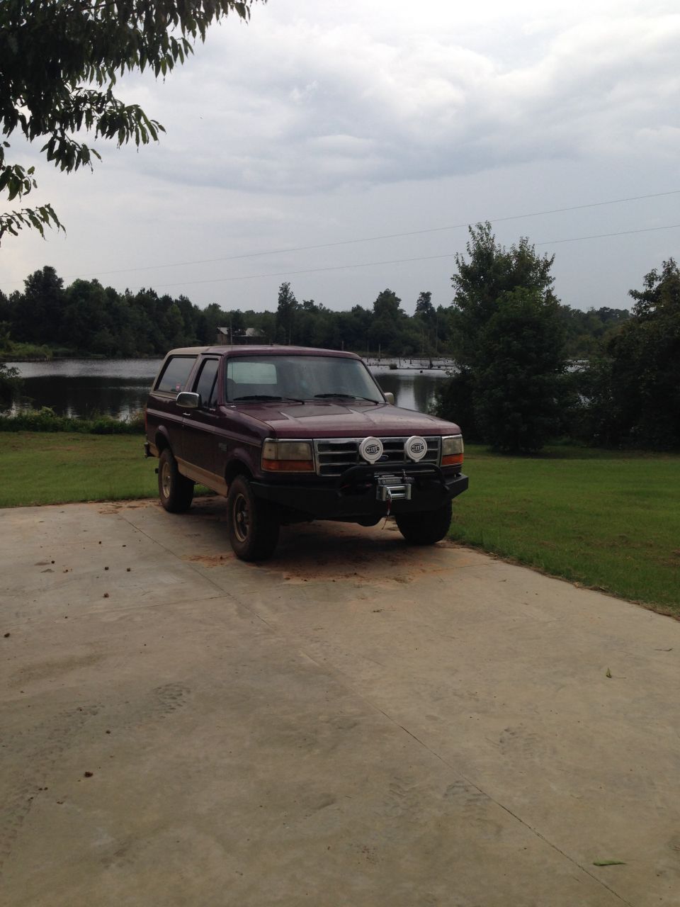 Maroon 1996 Ford Bronco with aftermarket bumper and winch
