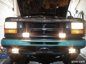 2000 Mercury Grand Marquis - Front view of a truck with its hood open, showing the headlights and grille.