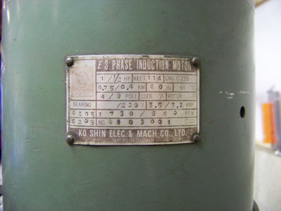 Nameplate on a green industrial electric motor showing "KO SHIN ELEC. & MACH CO., LTD."
