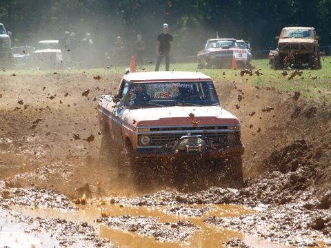 1978 Ford Bronco - This Ford pickup truck is navigating a challenging mud bog during an event.