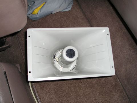 1996 Ford Bronco - A white horn speaker is placed on the carpeted floor of a vehicle, with a jacket in the background.