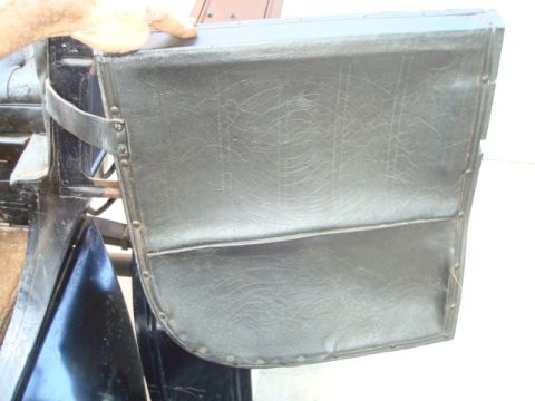 1912 Ford Model T - Close-up of a vintage car's interior door panel, showing its construction and material.